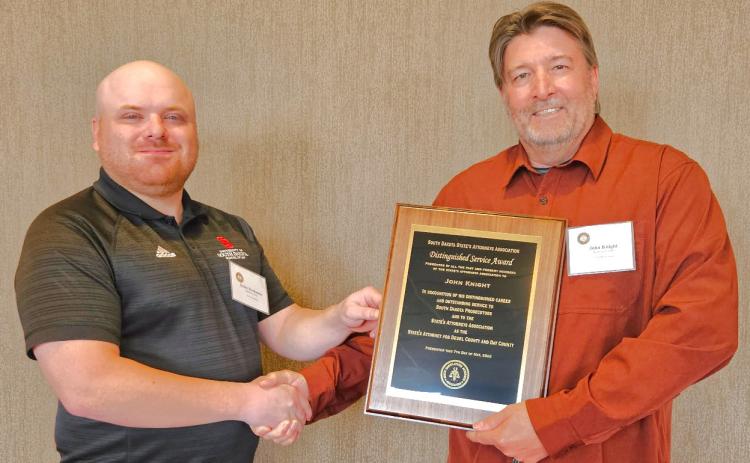 Roberts County State’s Attorney and Webster Area High School graduate Dylan Kirchmeier, left, awards Day County State’s Attorney John Knight, right, with the South Dakota State’s Attorneys Association 2025 Distinguished Reporter &amp; Farmer | subscriber snapshot Service Award.