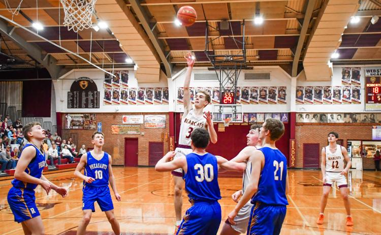 Seth Lesnar of Webster Area floats a shot over Redfield Pheasant defenders during the Bearcats 85-64 Region 1A playoff victory March 3 in Webster. The win was the Bearcats first regional playoff victory in 22 years spanning back to 2004. Reporter &amp; Farmer | Connor Handrahan