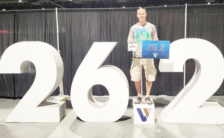 Waubay resident Curtis Huffman competed in the Las Vegas marathon Nov. 3 in Las Vegas, NV. Huffman said the conditions were extremely difficult at the start of the race with high winds and cold temperatures. Here, Huffman poses with his competition number in his right hand and a sign which displays the number of miles in a marathon while simultaneously standing on a larger display with the same figure. Reporter &amp; Farmer | Subscriber Snapshot