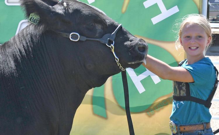 Posing with her reserve grand champion market beef is Kori Gaikowski during the Day County Fair Aug. 9. Reporter &amp; Farmer | Amanda Dulitz