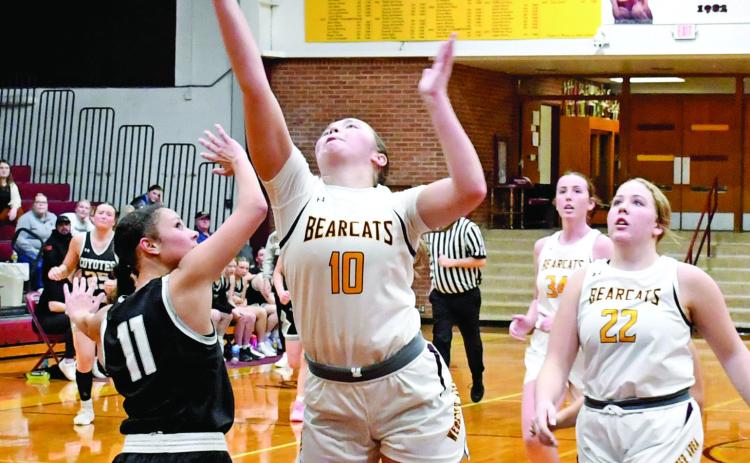 Webster Area Bearcats girls basketball hosted the Waverly/South Shore Coyotes Jan. 27. Bearcats won with a final score of 61-43. Here, Harley Johnson (10) attempts a layup as her teammates Bailee Ninke (22) and Erin Sannes (34) follow close behind while Waverly/South Shore’s Dashaya Koch (11) attempts to block the shot. Reporter &amp; Farmer | Robert Dulitz