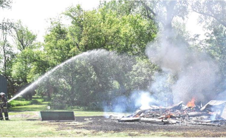 A shed started on fire near 439th Ave. east of Webster May 28. Waubay and Webster Fire Departments were called to scene. No report was available as of press deadline. Here, Webster fire fighter Leonard Deibert takes action to help put out the flames. Reporter &amp; Farmer | Connor Handrahan