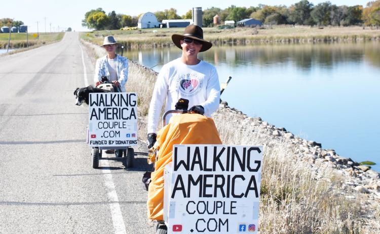 Torin and Paige Rouse walk with their dog Jak in their 12,000 mile journey which would result in them walking across every state. Here, the Rouse family walks just outside of Webster Oct. 7 as they prepared to finish up their trip in Watertown. Reporter &amp; Farmer | Brenner Cariveau