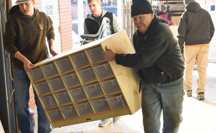 In order to renovate the Knapp &amp; Play Learning Center building for a Webster day care, old furniture was being transported to the Lake Region Business Center Feb. 21 for storage. Here from left, Caleb Gaikowski, Gabriel Gaikowski and Nathan Meland haul a large organizer into a storage area. Reporter &amp; Farmer | Brenner Cariveau