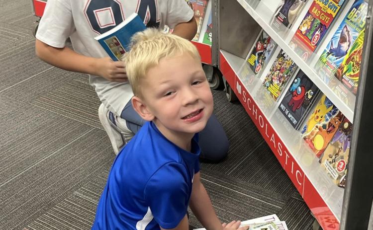 Webster Area held their book fair Oct. 5-8. Kids were able to go visit the school library all week long and purchase new and exciting stories for their entertainment. Here, Layla Nolte and her younger brother Jay Nolte enjoy looking through the book fair as their parents visit with their teachers. Reporter &amp; Farmer | Subscriber snapshot
