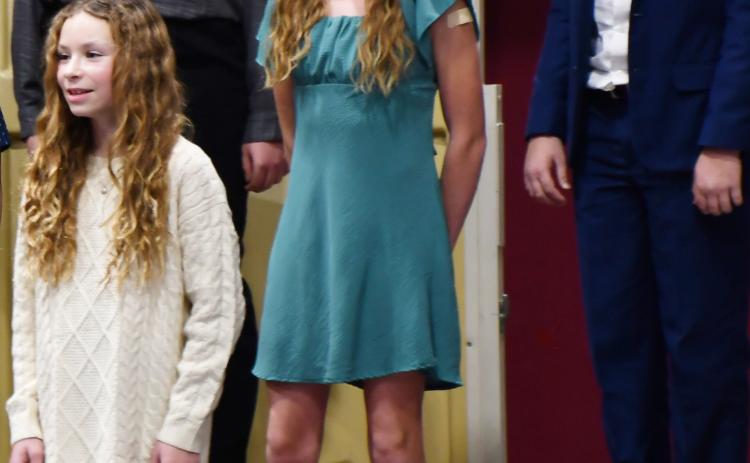 Webster Area students k-6 performed at the winter concert event Dec. 9 at the Webster Armory. Here, sixth graders left in back Kailani Andrade and Harrison Wagner; in middle row Portlyn Johnson and in front Embry Duenwald sing holiday songs. Reporter &amp; Farmer | Brenner Cariveau