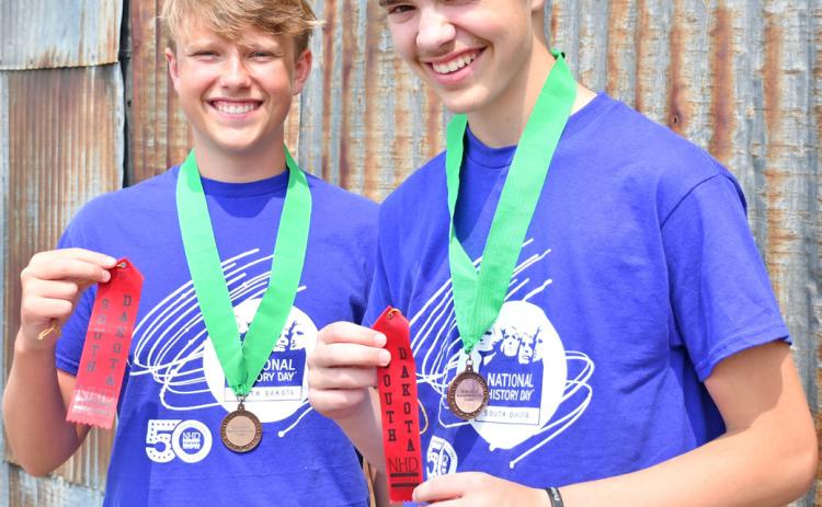 Jackson Baumgarn and Jase Voss smile as they hold ribbons they received from the National History Contest. The two traveled to Washington, DC to compete last month. Reporter &amp; Farmer | Annie Witt