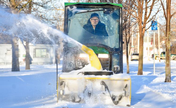 Brian Holland blows snow off a sidewalk outside Day County Courthouse March 18 in Webster. Reporter &amp; Farmer | Leyton Beardslee